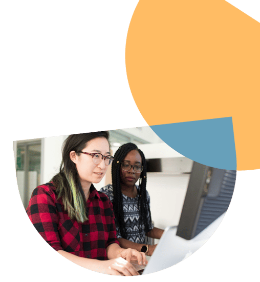 Two women wearing glasses looking at a computer screen Two women wearing glasses looking at a computer screen