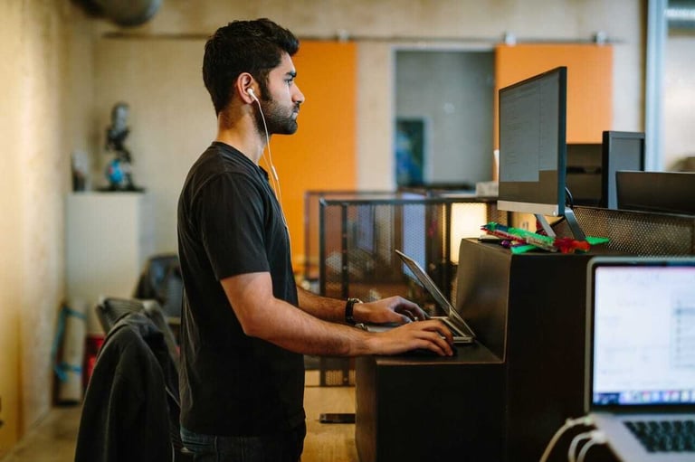 Person working at standing desk Person working at standing desk