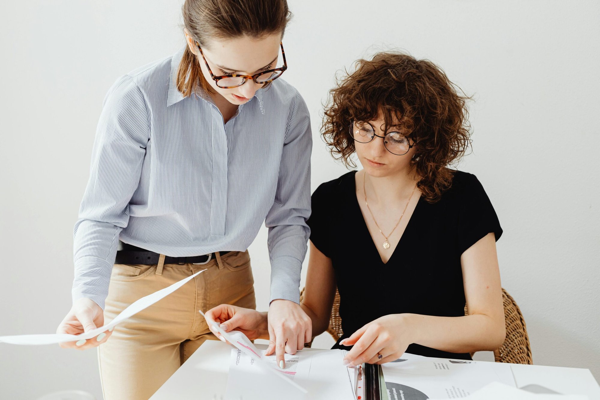 Photograph of two people looking at audit results together. Photograph of two people looking at audit results together.